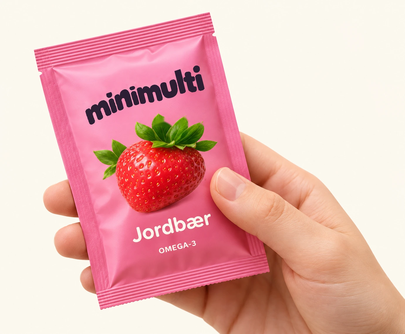 En MiniMulti-pose med jordbærsmak, holdt i en hånd